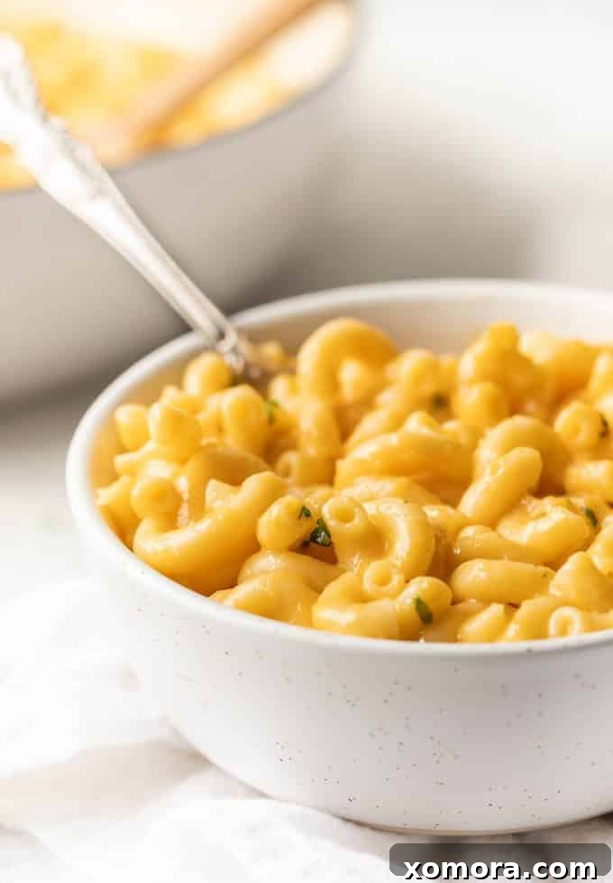 Velvety Homemade Mac & Cheese Delight 3 Close-up of the rich, smooth cheese sauce being made in a pot