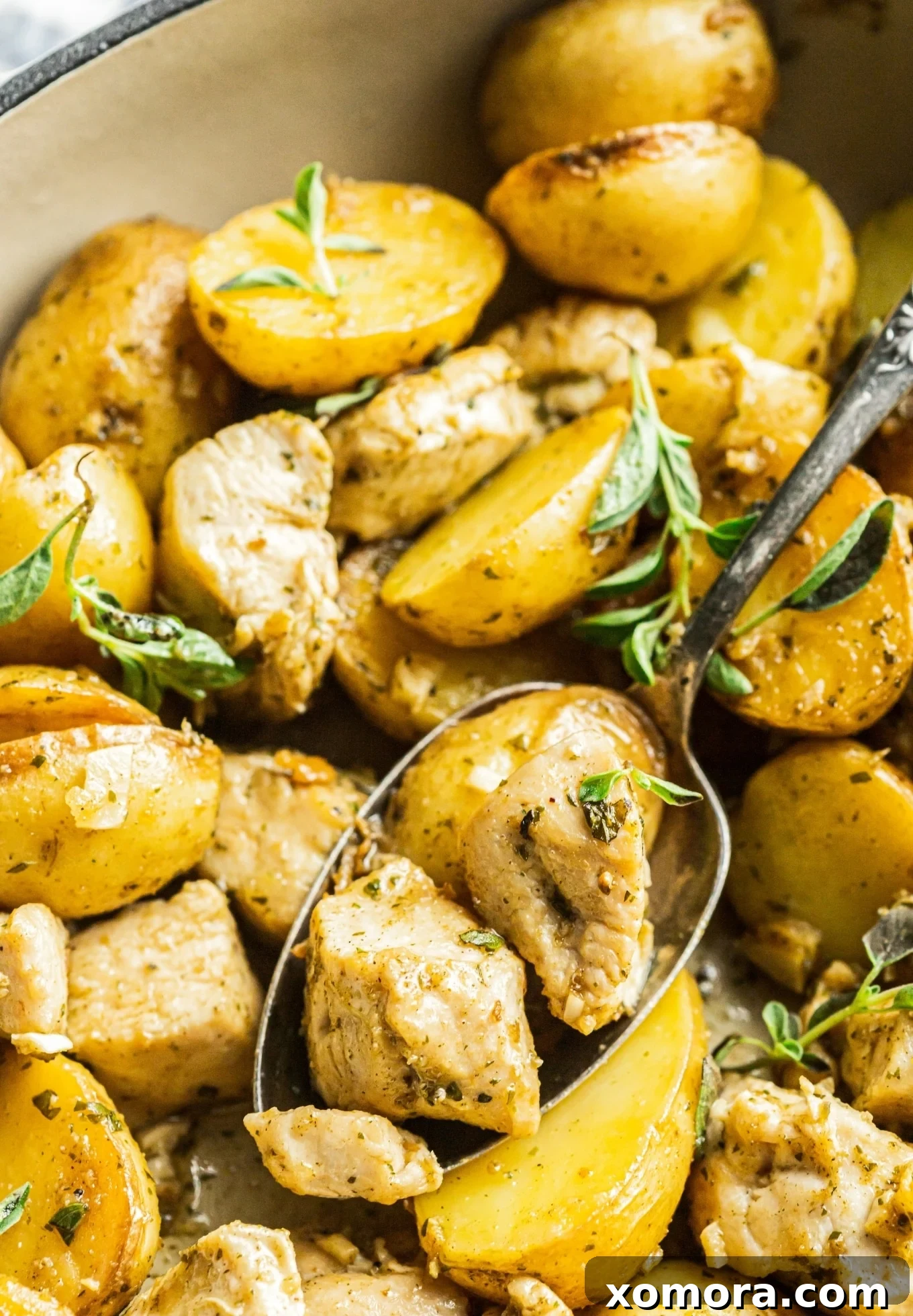 Mediterranean Lemon Herb Chicken and Potatoes 3 Skillet full of cooked Oregano Lemon Chicken and Potatoes, ready to serve.
