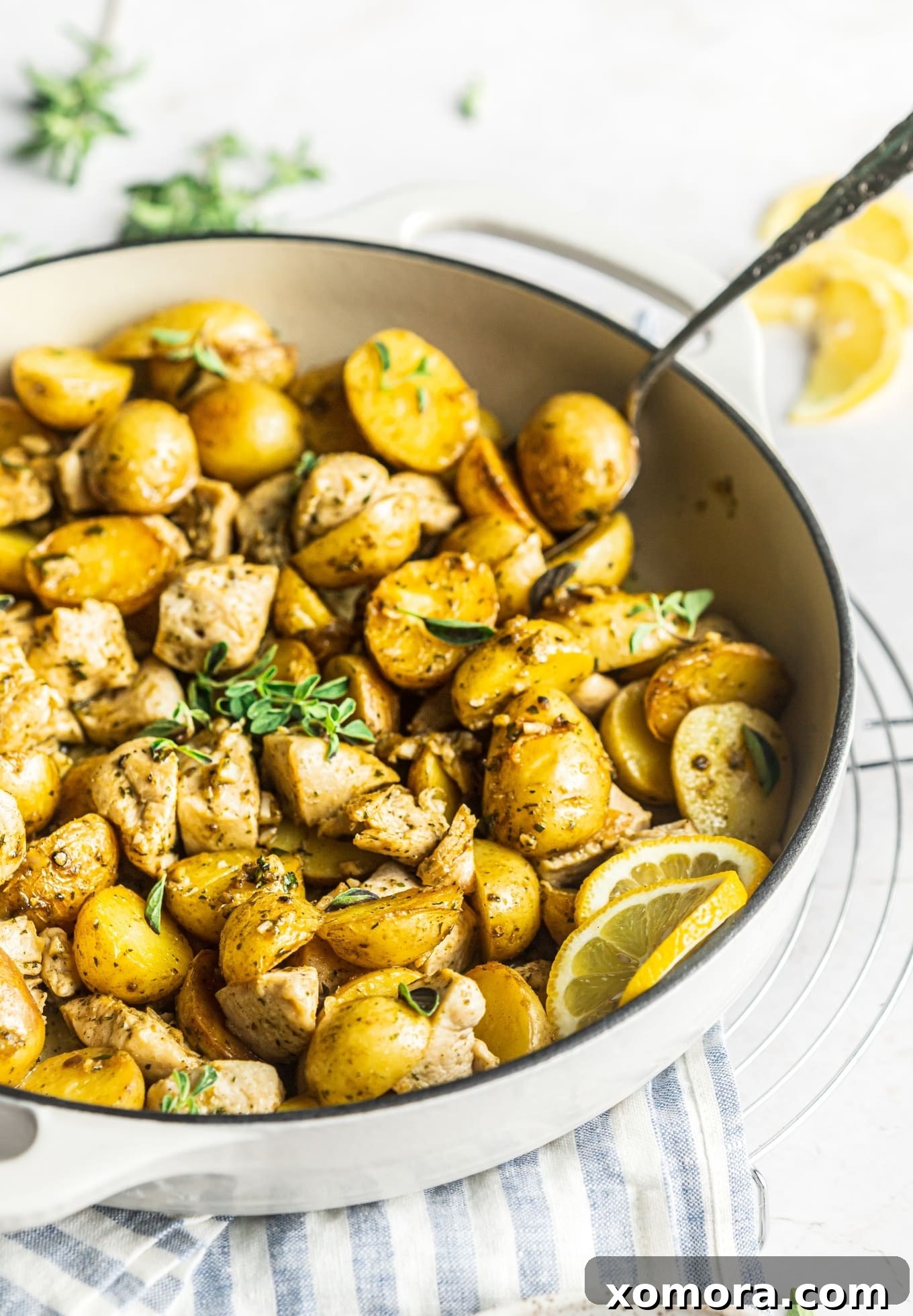 Mediterranean Lemon Herb Chicken and Potatoes 5 Close-up of Oregano Lemon Chicken and Potatoes in a white bowl, showing texture.