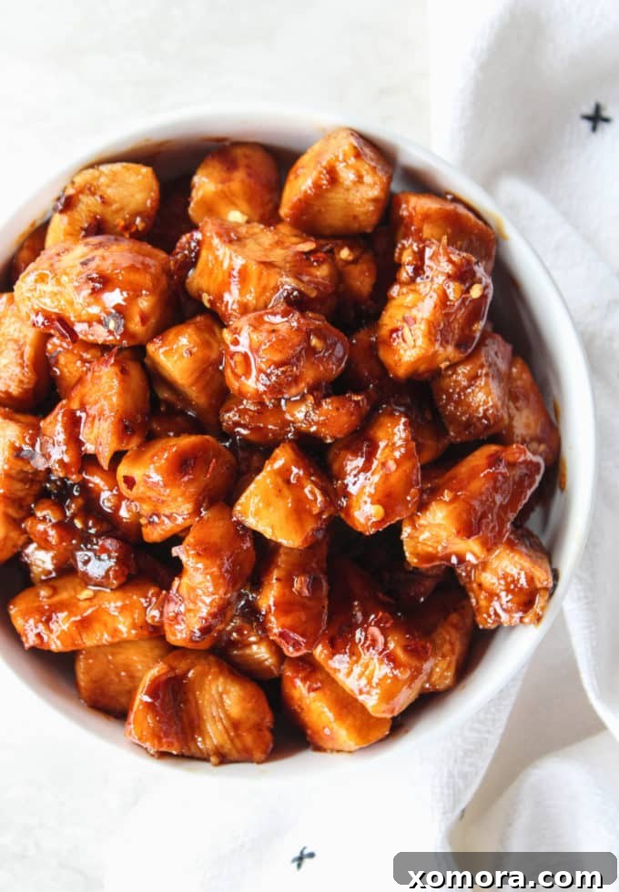 Sticky Sweet Heat Chicken Bites 2 Glistening Sweet & Spicy Chicken Bites in a skillet