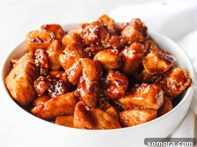 Sticky Sweet Heat Chicken Bites 3 Chicken pieces browning in a skillet before sauce is added