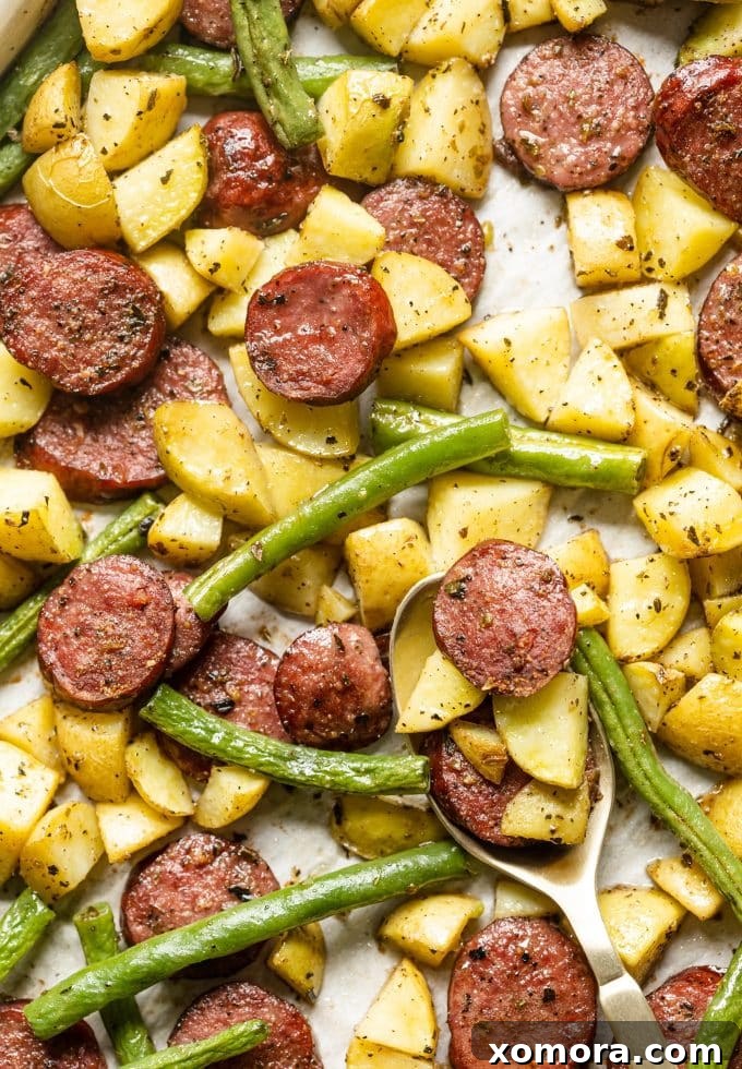 Sheet Pan Sausage and Roasted Vegetables 2 Sheet pan sausage, potatoes, and green beans roasted together on a baking sheet, ready for serving.