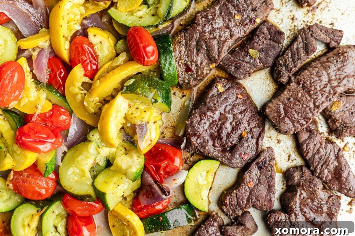 The marinated steak, ready to be added to the sheet pan with the already roasting vegetables.