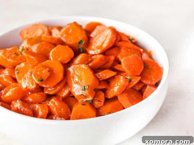 Caramelized Honey Carrots 4 A pan of sautéed honey carrots simmering in a sticky, sweet glaze.