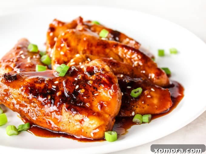 15-Minute Sticky Honey Chicken 3 Close-up of the honey sauce bubbling in the pan around seared chicken pieces.