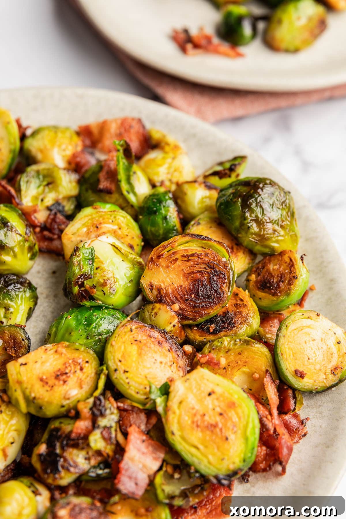 Balsamic Glazed Bacon Brussels Sprouts 2 Bacon and Balsamic Glazed Brussels Sprouts served in a skillet, showcasing golden brown edges and crispy bacon bits.