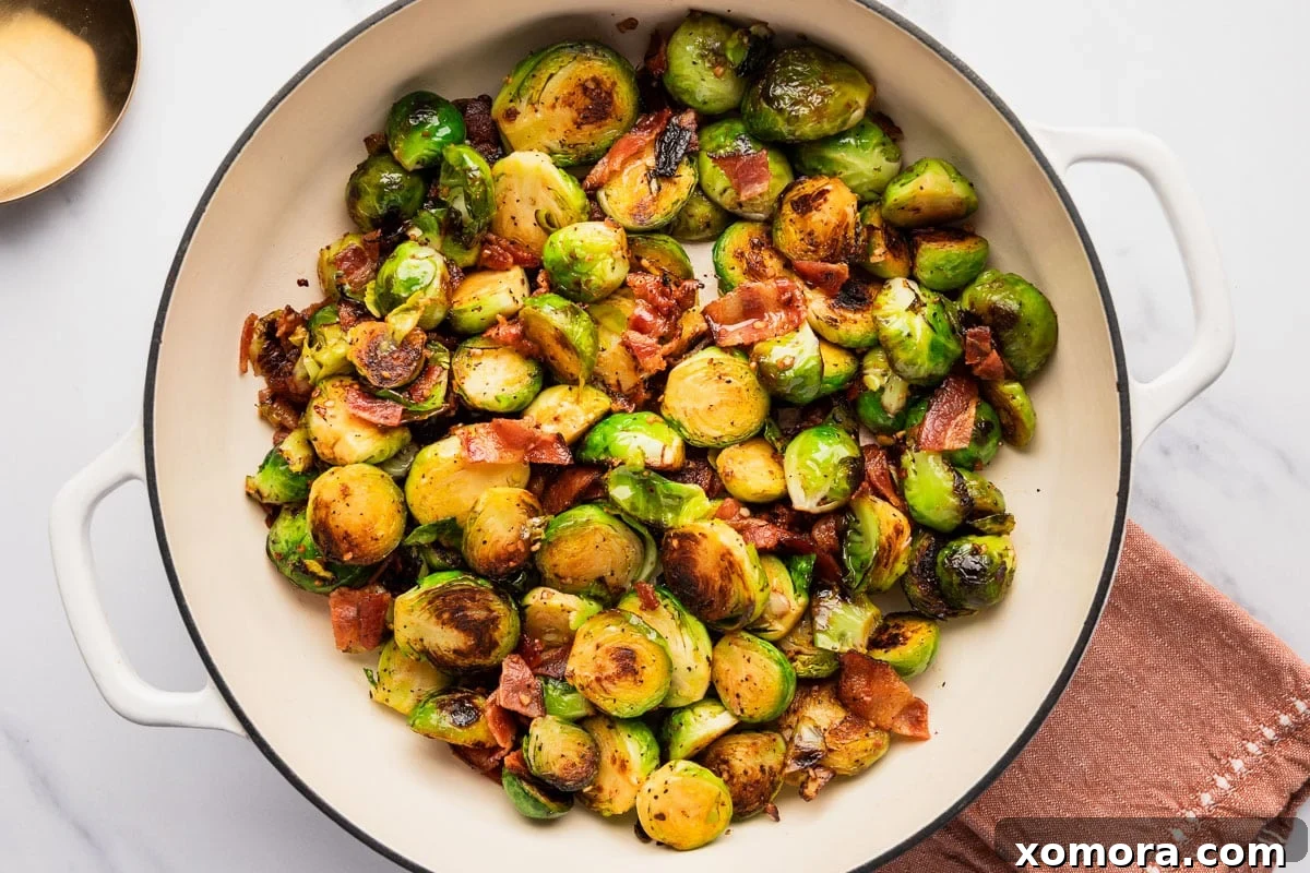 Balsamic Glazed Bacon Brussels Sprouts 5 A close-up of a pan of Balsamic Bacon Brussels Sprouts simmering on the stove, showing the rich color of the balsamic glaze and the texture of the sprouts.