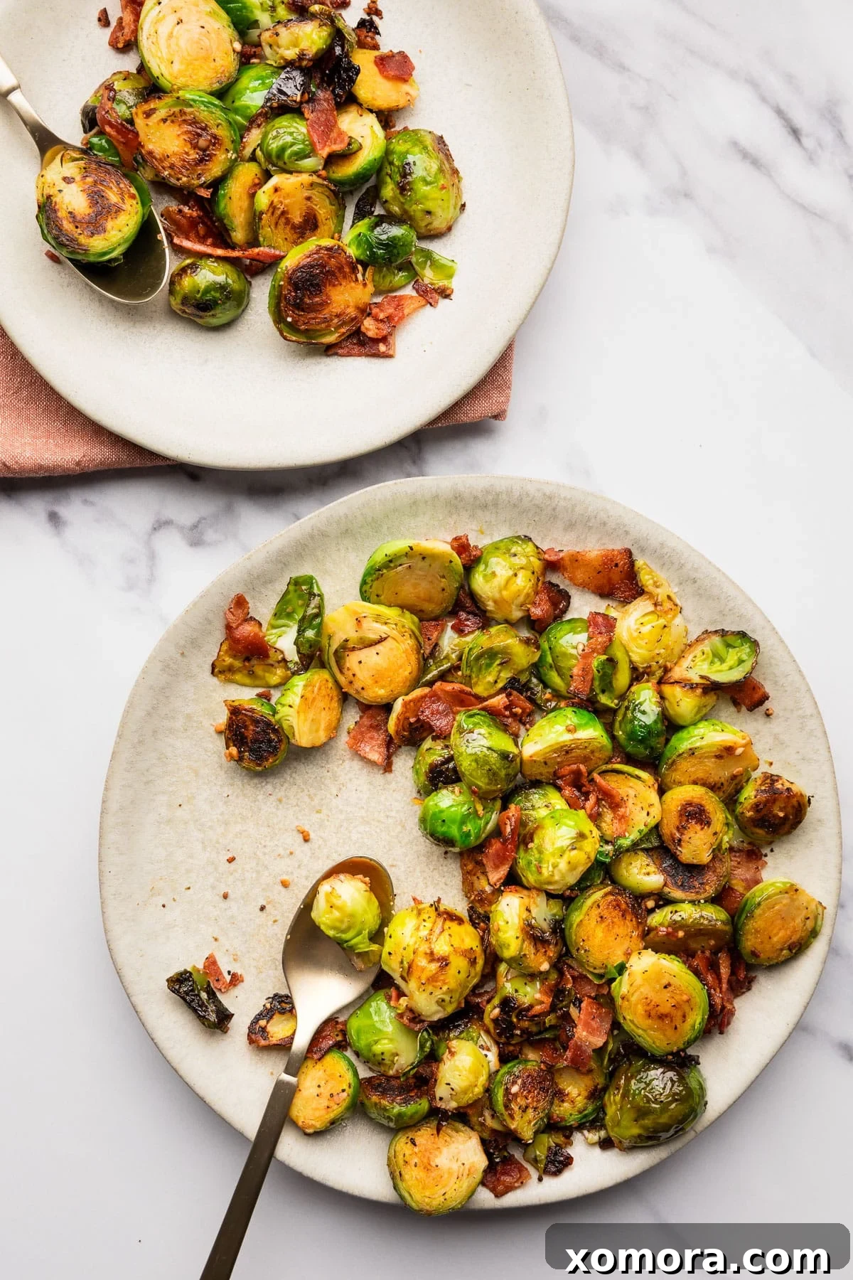 Balsamic Glazed Bacon Brussels Sprouts 6 A cutting board with brussels sprouts being trimmed and halved, demonstrating the preparation process.