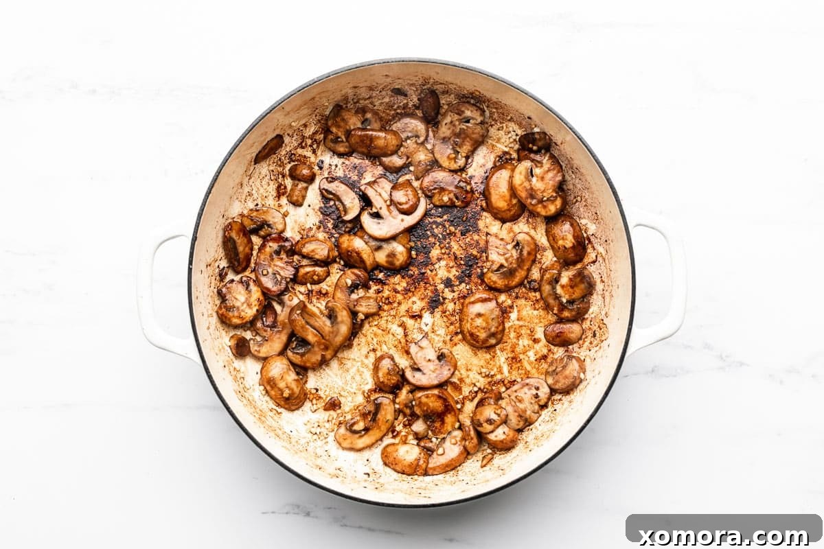 Tender Skillet Steak Bites in Rich Mushroom Gravy 4 Ingredients for Skillet Steak Bites in Mushroom Gravy laid out on a cutting board.