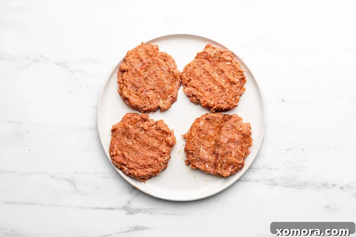 Dijon Turkey Burgers on the Grill 4 Raw Dijon turkey burger patties in a bowl before grilling.