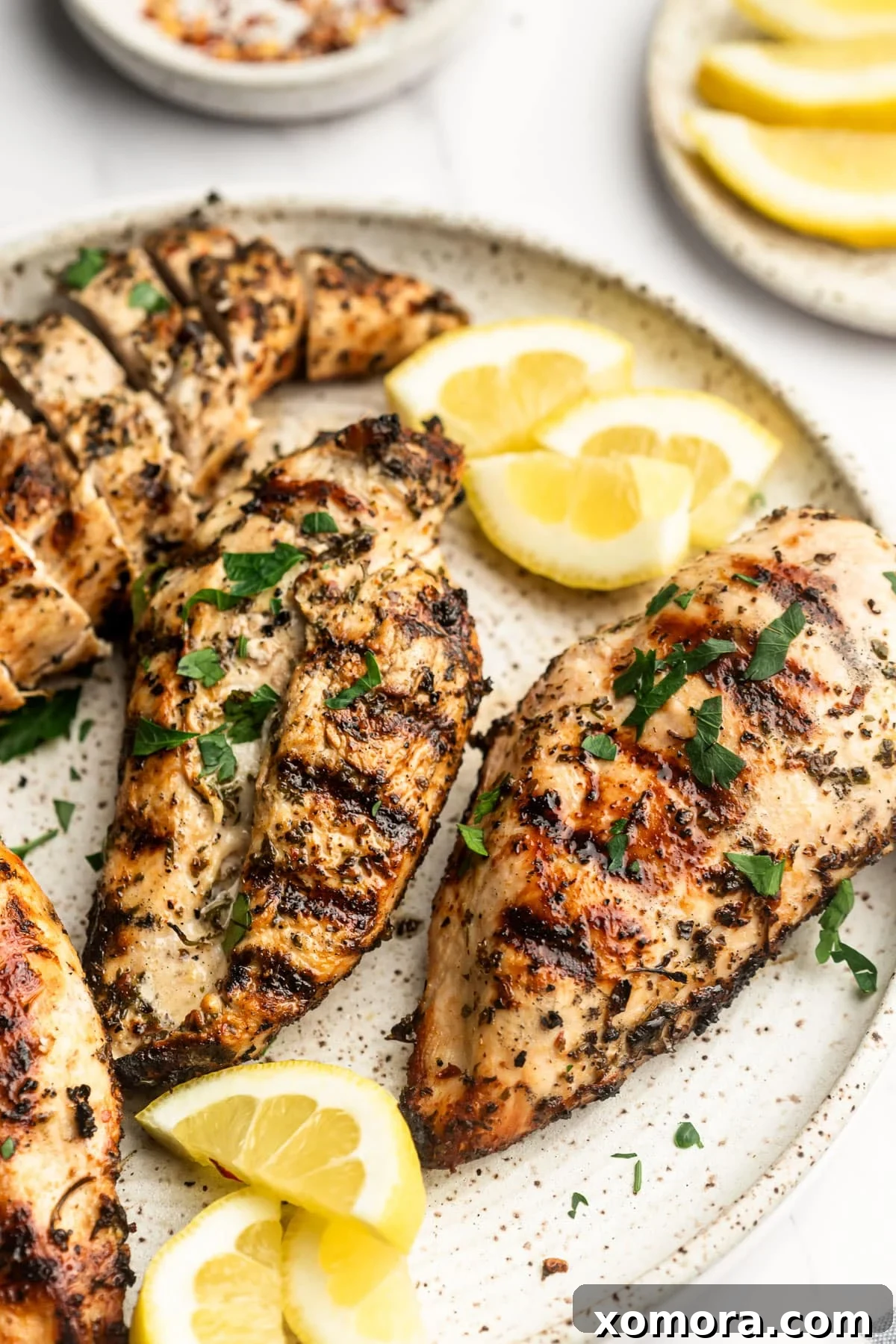Vibrant Lemon Herb Grilled Chicken 6 Ready-to-serve grilled lemon herb chicken, garnished with fresh lemon and parsley.