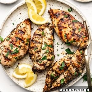 A perfectly cooked grilled lemon herb chicken breast.