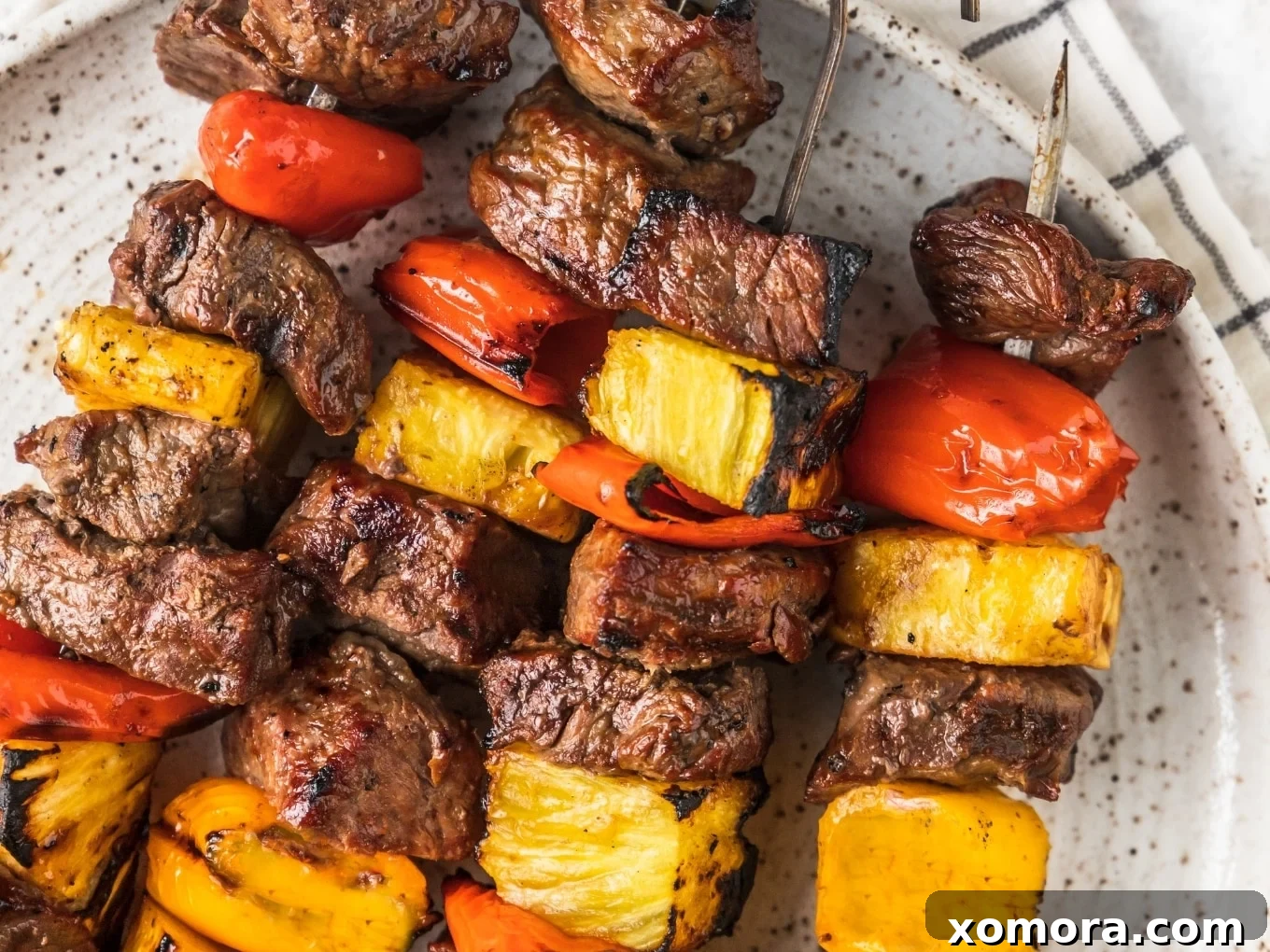 Wholesome Grilling Delights 22 Grilled Hawaiian Steak Kabobs, beautifully charred with pineapple and peppers.