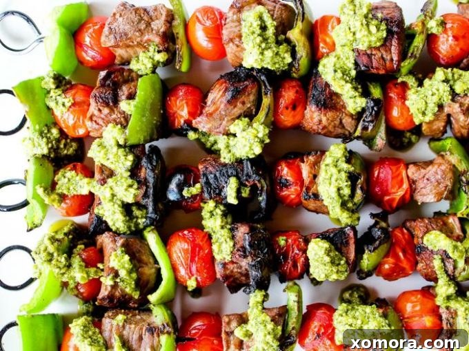 Wholesome Grilling Delights 27 Pesto Steak Kabobs with Blistered Tomatoes & Peppers, beautifully arranged on a serving plate.