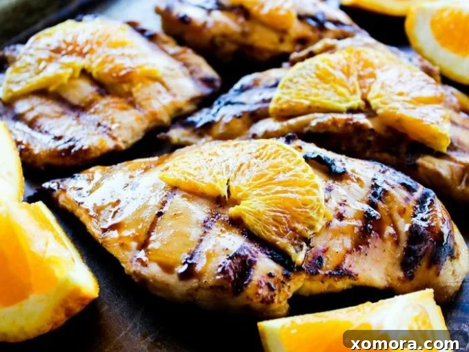 Wholesome Grilling Delights 31 Grilled Orange Chicken, featuring chicken breasts with a citrus glaze and orange slices.