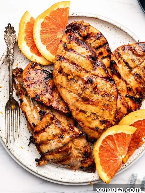 Wholesome Grilling Delights 32 Close-up of grilled orange honey chicken, showing the caramelized exterior and citrus zest.