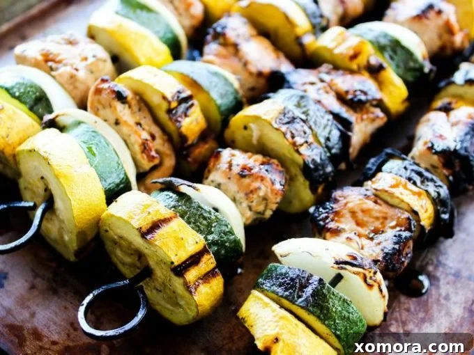 Wholesome Grilling Delights 5 Grilled Garlic Balsamic Chicken Kabobs on a platter, showcasing colorful vegetables and chicken.