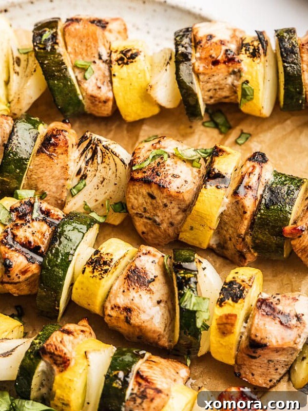 Wholesome Grilling Delights 6 Skewered chicken and vegetables, glistening with a balsamic glaze on a grill.