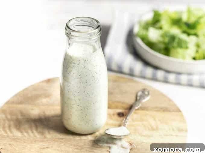 Flavorful & Guilt-Free Salad Dressings 11 Thick, creamy Dairy Free Ranch Dressing & Dip in a bowl with fresh herbs and vegetables.