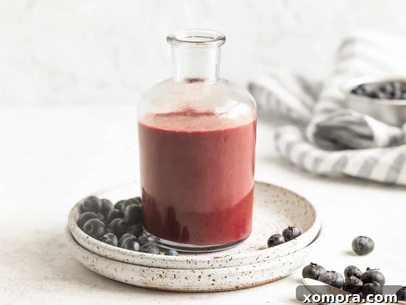 Flavorful & Guilt-Free Salad Dressings 8 Close-up of a glass bottle containing smooth, purple Blueberry Dressing.