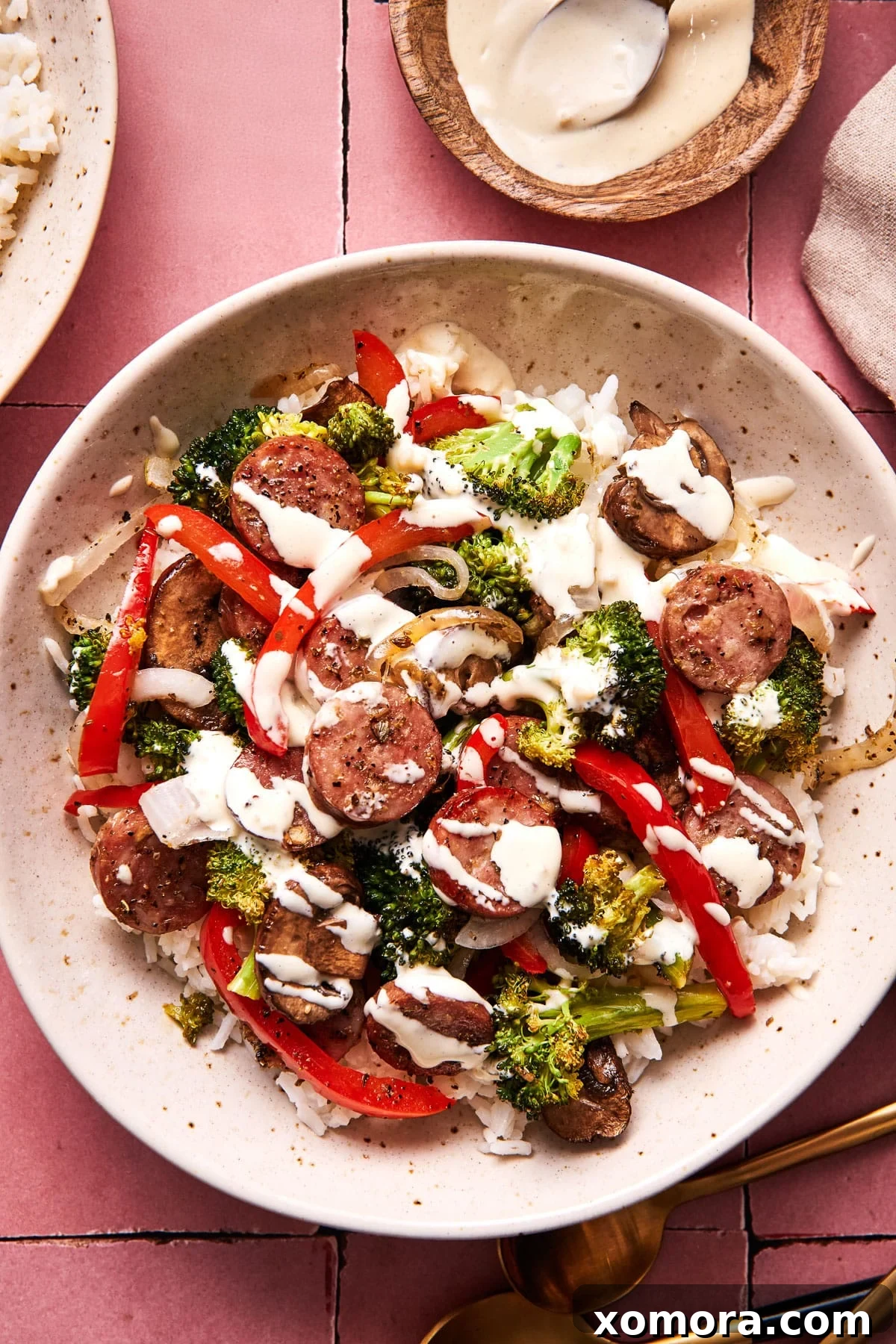 Sausage & Veggie Power Bowls with Zesty Mustard 2 A vibrant sheet pan meal with roasted sausage, broccoli, mushrooms, bell pepper, and onion, drizzled with mustard sauce.