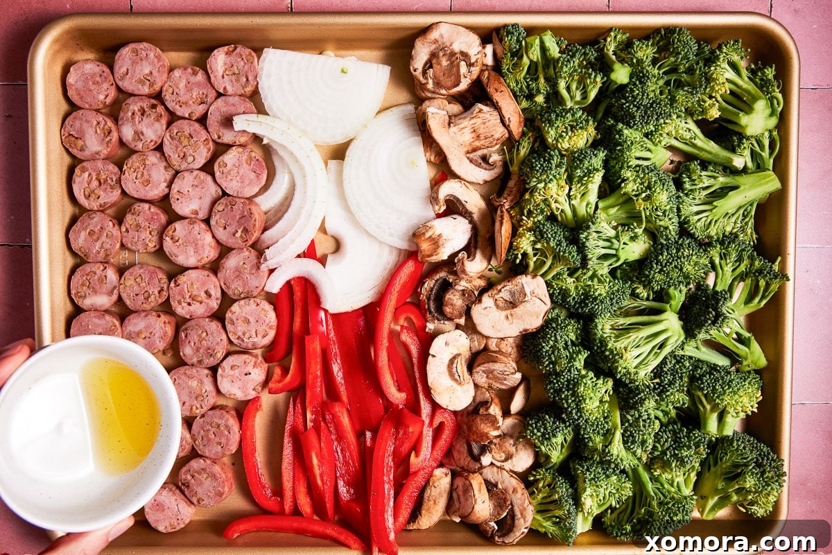 Sausage & Veggie Power Bowls with Zesty Mustard 3 Close-up of roasted sausage and vegetables on a sheet pan, ready to be served.