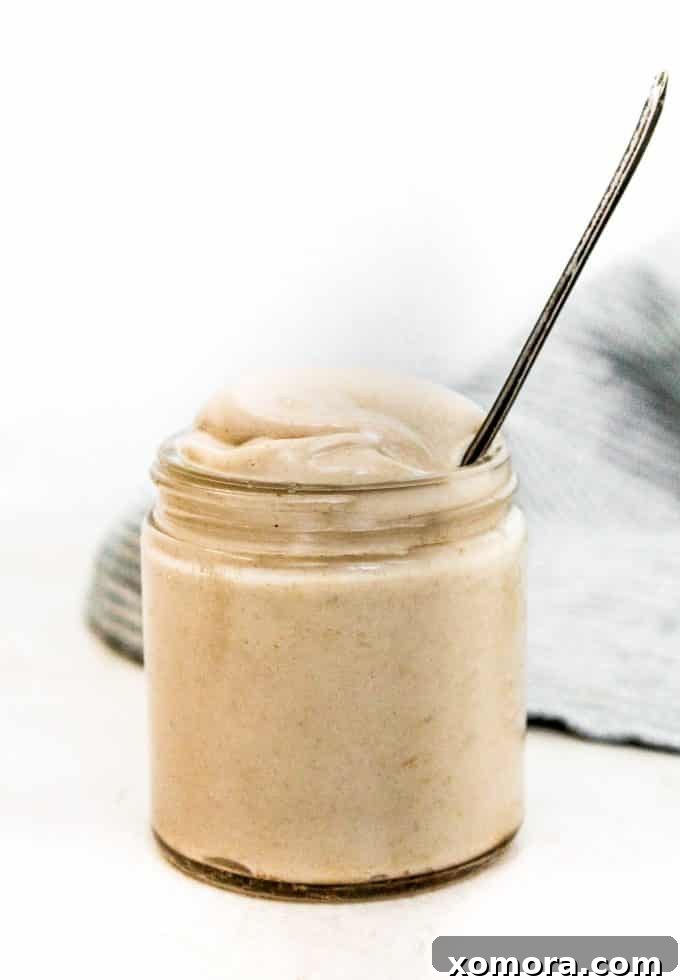 Effortless Mustard Delight 4 Freshly made creamy Dijon mustard sauce in a small ceramic bowl, ready to be enjoyed.