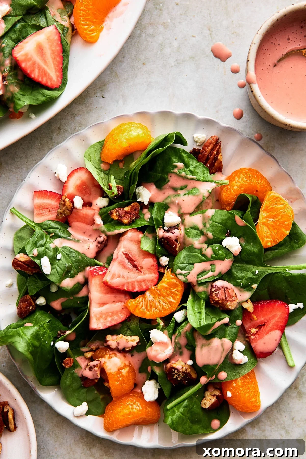 Gourmet Strawberry Goat Cheese Spinach Salad 6 Full bowl of Strawberry Goat Cheese Spinach Salad on a white table