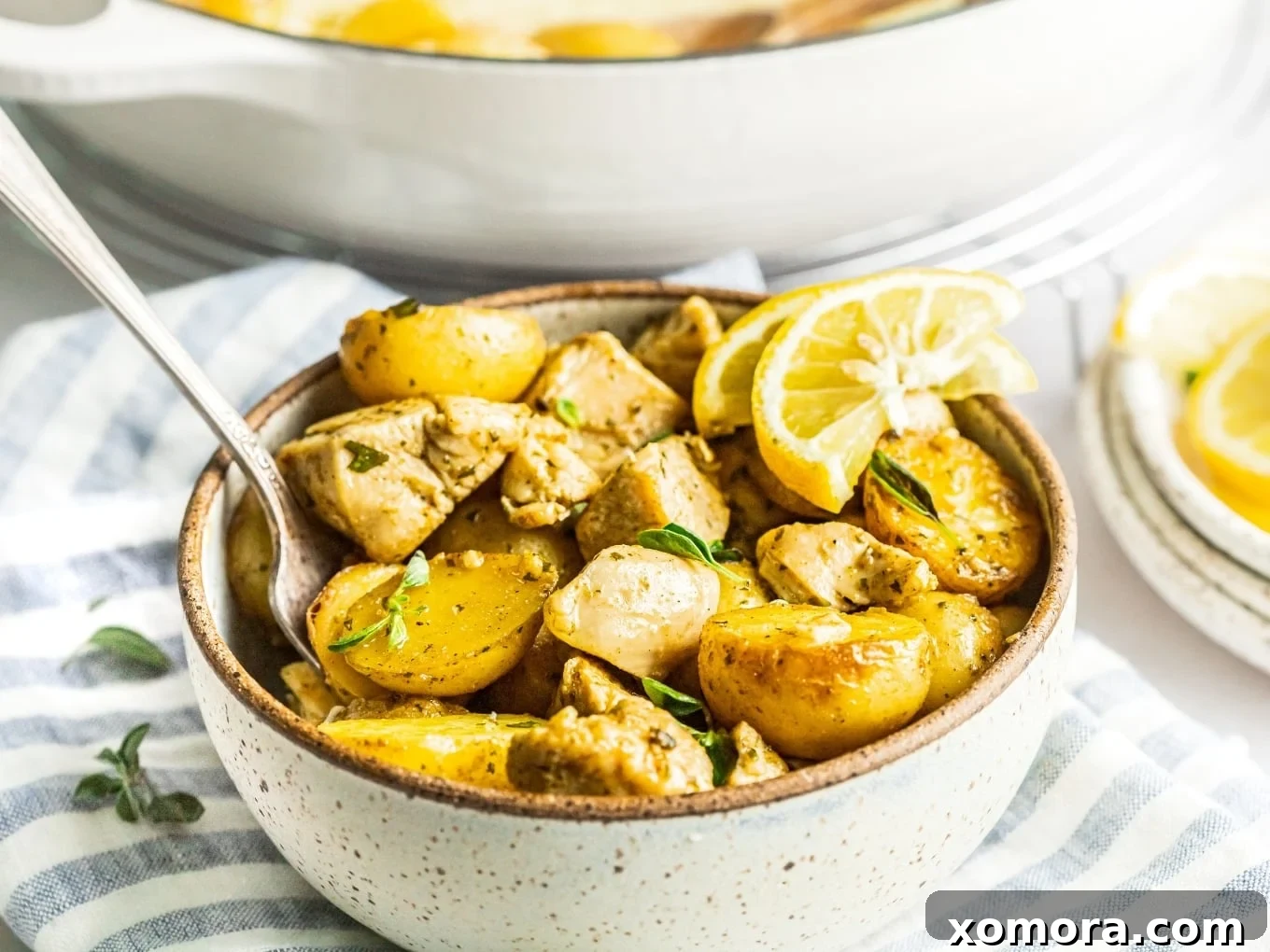Reader-Approved Healthy Dinners 3 Oregano Lemon Chicken and Potatoes cooked in a skillet.