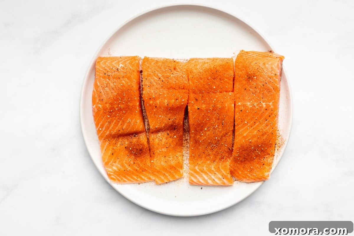 Smoky Zesty Salmon Skillet 3 Close-up of a pan-seared salmon fillet on a plate, showcasing its golden brown skin.