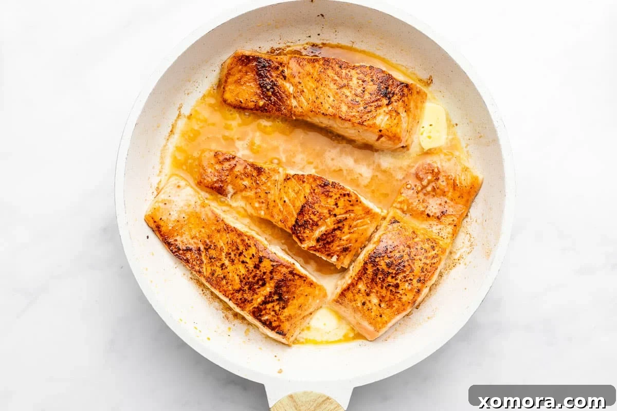 Smoky Zesty Salmon Skillet 4 Freshly pan-seared chipotle lime salmon garnished with parsley in a skillet.