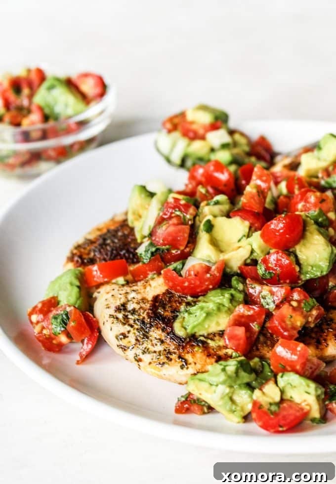 Fiesta Chicken with Avocado Salsa 2 Perfectly Sautéed Chicken with Fresh Avocado Salsa on Top, garnished with cilantro