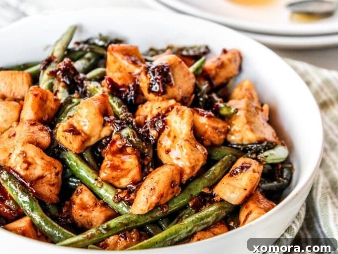 Close-up of fresh green beans and canned chipotle peppers in adobo sauce, key ingredients for the recipe