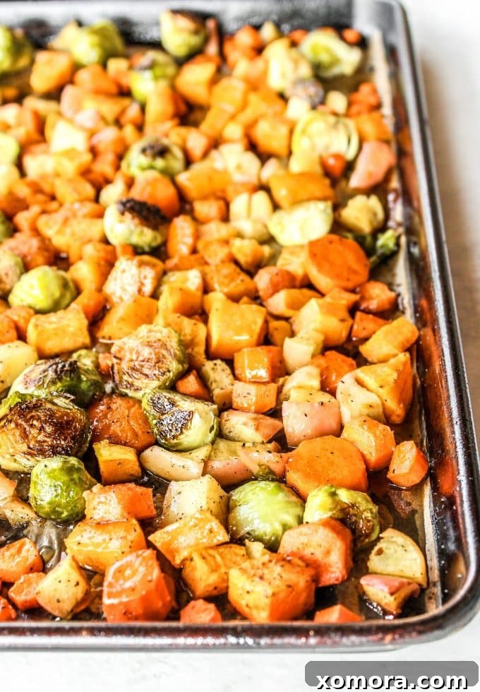Golden Maple Glazed Roasted Vegetables 4 Close-up of roasted Brussels sprouts, carrots, sweet potatoes, and apples, glazed with maple syrup