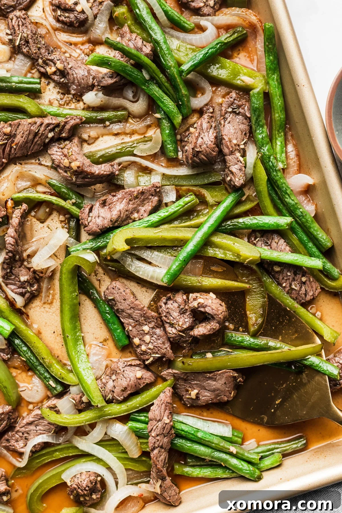 Effortless Sheet Pan Beef Tips and Roasted Veggies 2 Close-up of Sheet Pan Beef Tips with Vegetables, featuring tender beef chunks, green beans, onions, and bell peppers.