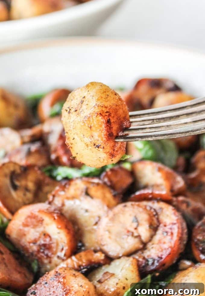 Comforting Sausage and Mushroom Cauliflower Gnocchi 6 Finished Sausage & Mushroom Cauliflower Gnocchi in a bowl with a fork