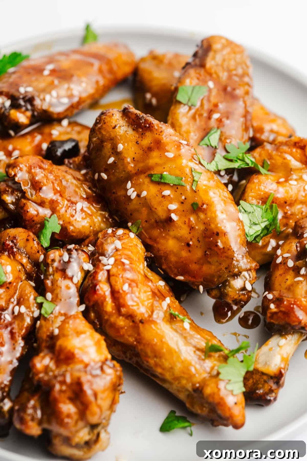 Platter of honey garlic chicken wings with fresh herbs