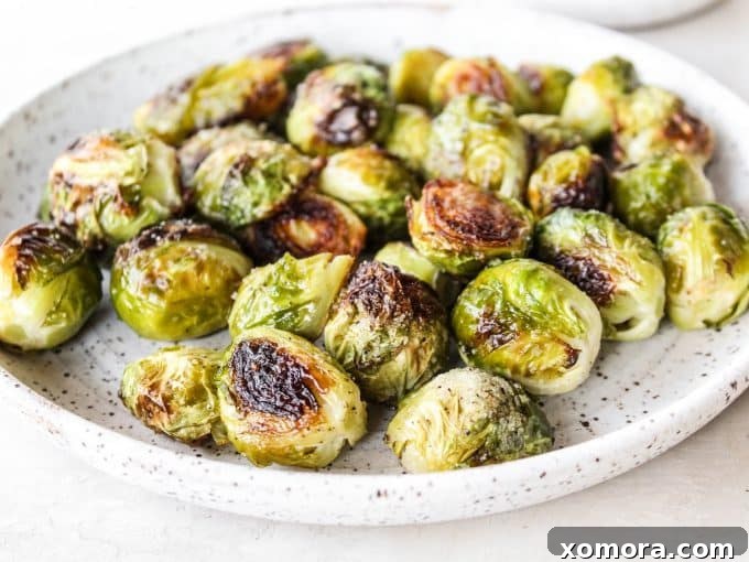 Crispy Caramelized Brussels Sprouts 5 Roasted Brussels sprouts mixed with parmesan cheese and herbs, ready to be served.