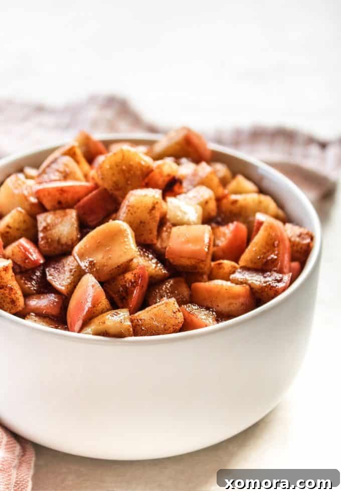 Maple Glazed Sautéed Apples 2 Close-up of golden brown maple sweetened sautéed apples in a skillet.