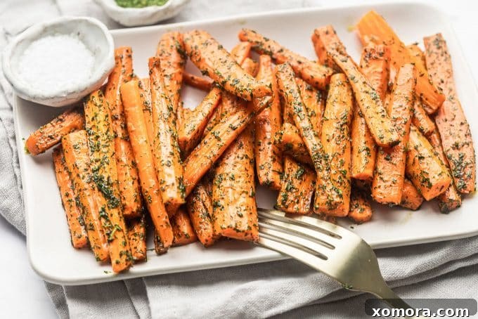 Sliced carrots ready for roasting on a wooden cutting board