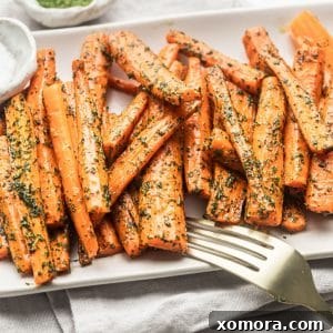 Close-up of roasted carrots with parsley in a serving bowl