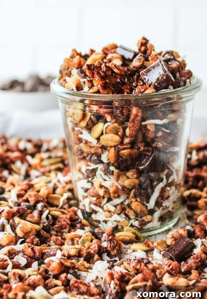 Irresistible Grain Free Chocolate Chunk Granola 2 A close-up shot of homemade grain-free chocolate chunk granola in a bowl, showcasing crunchy clusters, nuts, and chocolate pieces.