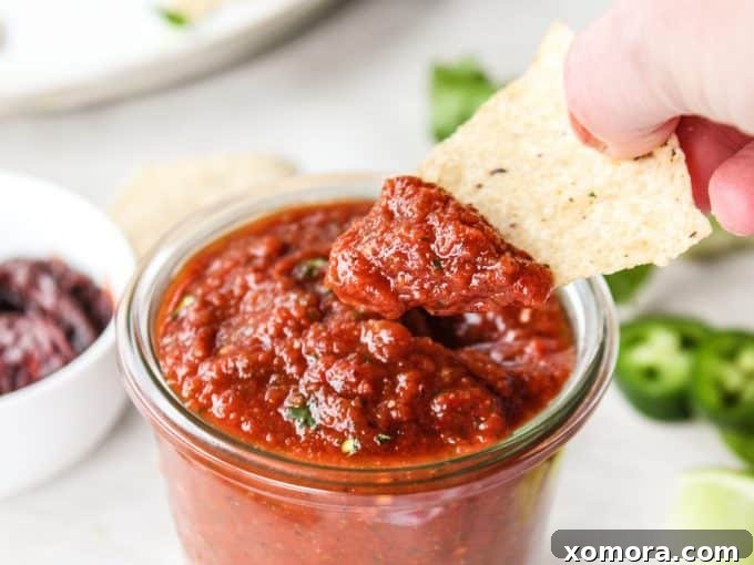 Smoky 5-Minute Chipotle Salsa 5 A generously sized bowl of fresh chipotle blender salsa with tortilla chips for dipping.