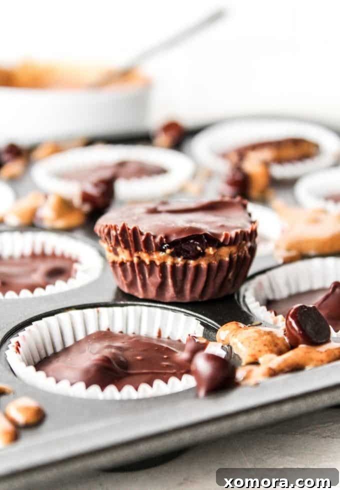 Delicious no-bake almond butter and jelly cups in cupcake liners, ready to be enjoyed.