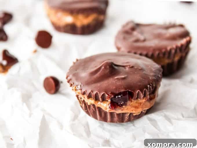 Melted chocolate and coconut oil in a bowl, ready for layering almond butter and jelly cups.
