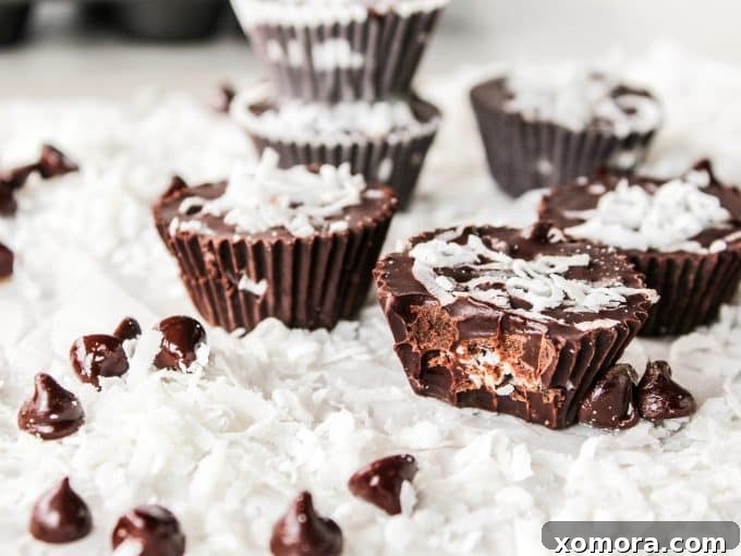 Dark Chocolate Coconut Bliss Bites 5 Four perfectly set dark chocolate coconut cups presented, highlighting their deep chocolate color and texture
