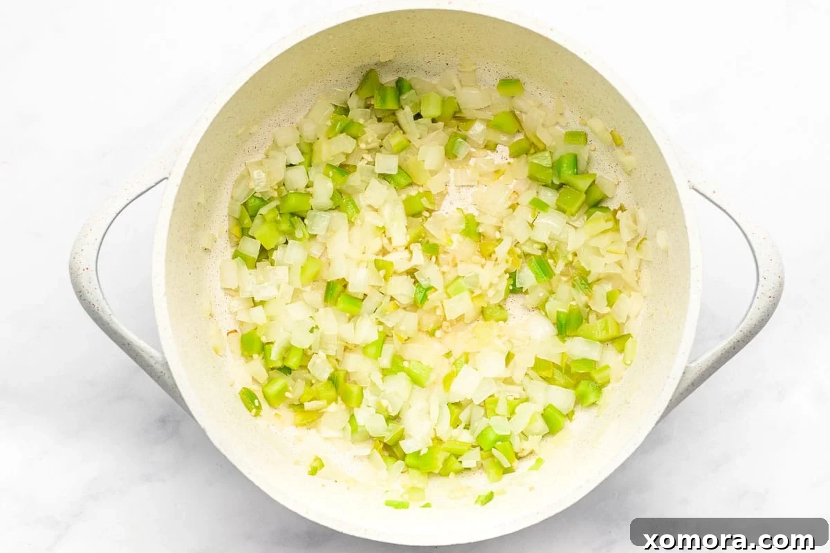Wholesome Keto Chicken Cauliflower Soup 3 Close-up of the Chicken and Cauliflower Rice Soup with a spoon, highlighting the ingredients.