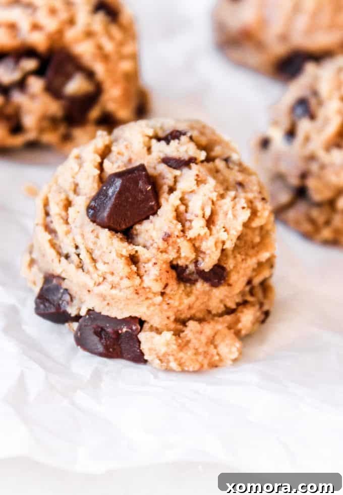 Wholesome Grain-Free Cookie Dough Delights 4 A bowl of grain-free cookie dough with a spoon resting in it, showing its ready-to-eat texture.