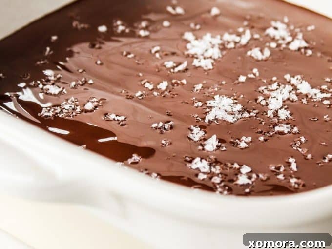 Grain Free Egg Free Cookie Dough Bliss 4 A cutting board with neatly sliced cookie dough bars, featuring distinct layers of dough and chocolate