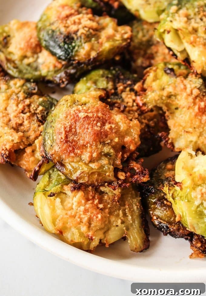 Crispy Parmesan Smashed Brussels Sprouts 2 Crispy Smashed Parmesan Brussels Sprouts on a baking sheet, fresh out of the oven.